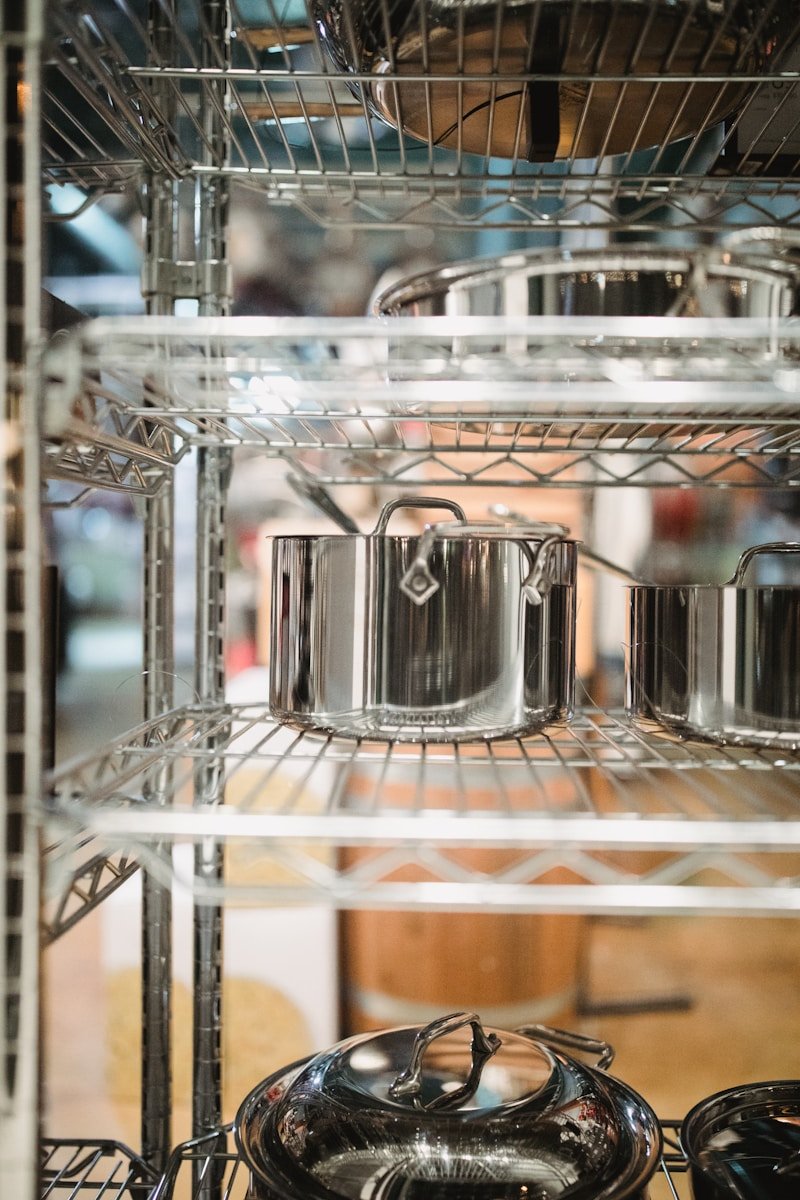 gray stainless steel stock pots on rack